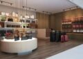 Interior of a retail space featuring various handbags and luggage on display.