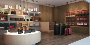 Interior of a retail space featuring various handbags and luggage on display.