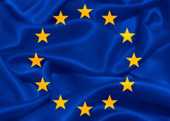 European Union flag featuring a blue background with a circle of twelve yellow stars.