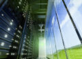 Interior view of a data center showing server racks and large windows with a view of the sky.
