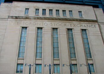 Facade of the Toronto Stock Exchange building featuring large windows and engraved text.
