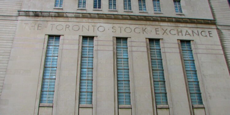 Facade of the Toronto Stock Exchange building featuring large windows and engraved text.