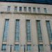 Facade of the Toronto Stock Exchange building featuring large windows and engraved text.