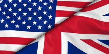 Flags of the United States and the United Kingdom overlapping each other.