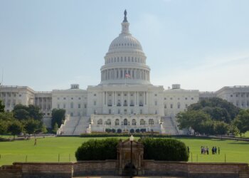 The United States Capitol building with a dome and steps leading up to the entrance.