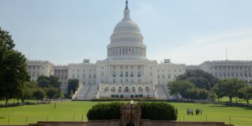 The United States Capitol building with a dome and steps leading up to the entrance.