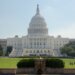 The United States Capitol building with a dome and steps leading up to the entrance.