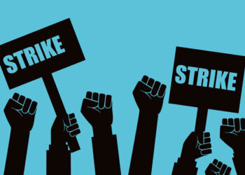 Illustration of multiple raised fists holding signs that say 'Strike' against a blue background.