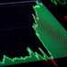 Stock market graph displaying a fluctuating line in green and red on a dark background.