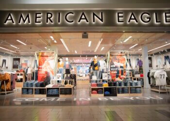 Exterior view of an American Eagle store featuring clothing displays and signage.
