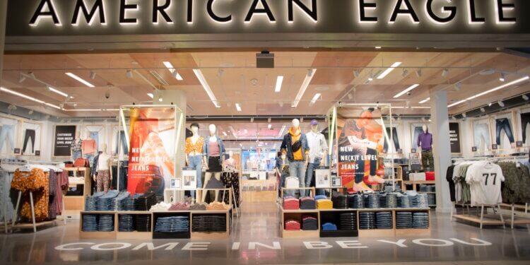 Exterior view of an American Eagle store featuring clothing displays and signage.