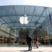 Exterior view of an Apple Store featuring a large glass facade and the Apple logo.