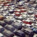 Aerial view of a parking lot filled with numerous cars in different colors and models.