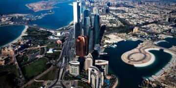 Aerial view of the Abu Dhabi skyline featuring modern skyscrapers and coastal areas.