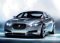 Silver Jaguar car model with sleek design and illuminated headlights on a neutral background.