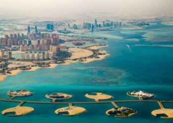 Aerial view of coastal development featuring islands and buildings along the shoreline.