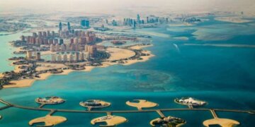 Aerial view of coastal development featuring islands and buildings along the shoreline.