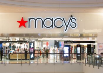 Macy's store entrance with illuminated signage in a shopping mall setting.