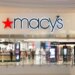 Macy's store entrance with illuminated signage in a shopping mall setting.