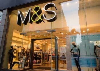 Entrance of an M&S store featuring mannequins and a large sign.