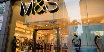 Entrance of an M&S store featuring mannequins and a large sign.