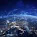A digital representation of global internet connectivity over a nighttime view of Earth.