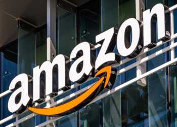 Amazon logo displayed on the exterior of a building with a prominent orange arrow.