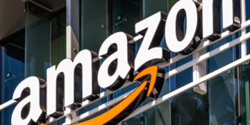 Amazon logo displayed on the exterior of a building with a prominent orange arrow.