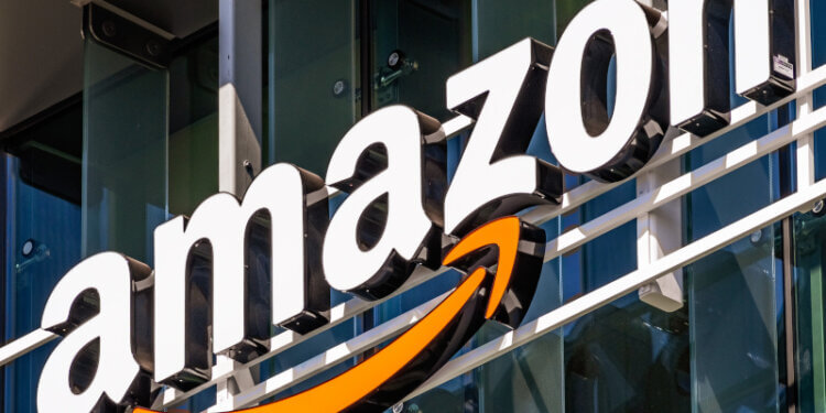 Amazon logo displayed on the exterior of a building with a prominent orange arrow.