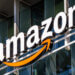 Amazon logo displayed on the exterior of a building with a prominent orange arrow.
