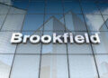 Signage of Brookfield Asset Management displayed on a glass building exterior.