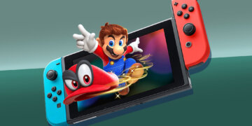 Nintendo Switch console with Mario character and red hat displayed on the screen.