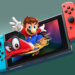 Nintendo Switch console with Mario character and red hat displayed on the screen.