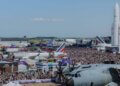 Aerial view of the Paris Air Show 2023 with numerous aircraft and a large crowd of attendees.