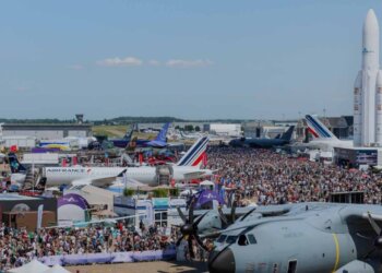 Aerial view of the Paris Air Show 2023 with numerous aircraft and a large crowd of attendees.