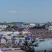 Aerial view of the Paris Air Show 2023 with numerous aircraft and a large crowd of attendees.