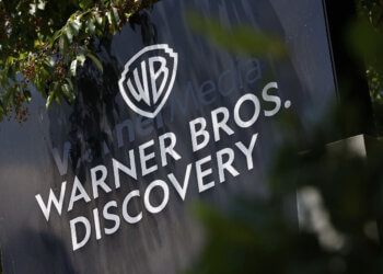 Sign displaying the Warner Bros. Discovery logo with the WB shield and company name.