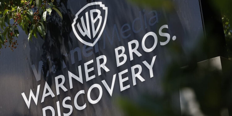 Sign displaying the Warner Bros. Discovery logo with the WB shield and company name.
