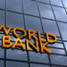 Sign displaying the words 'World Bank' on a glass building facade.