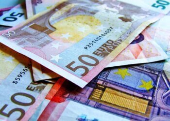 Close-up view of various Euro banknotes, including 50 Euro notes, stacked together.