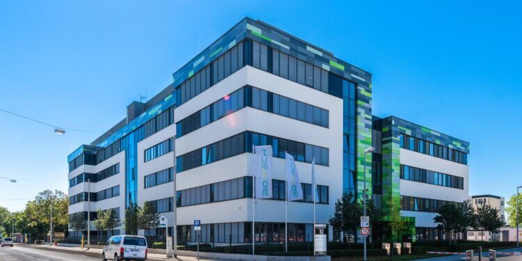 Contemporary office building featuring a mix of white and green architectural elements.