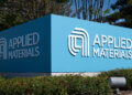 Blue sign displaying the logo and name of Applied Materials at their facility.