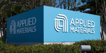 Blue sign displaying the logo and name of Applied Materials at their facility.