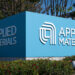 Blue sign displaying the logo and name of Applied Materials at their facility.