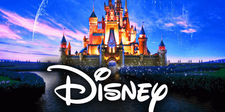 Illuminated Disney castle with the Disney logo in front of a blue sky background.